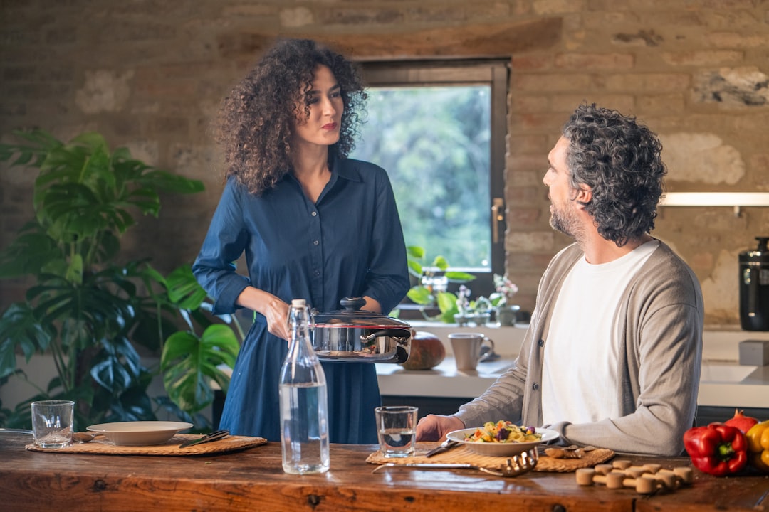 Couple cooking together in a rustic kitchen.