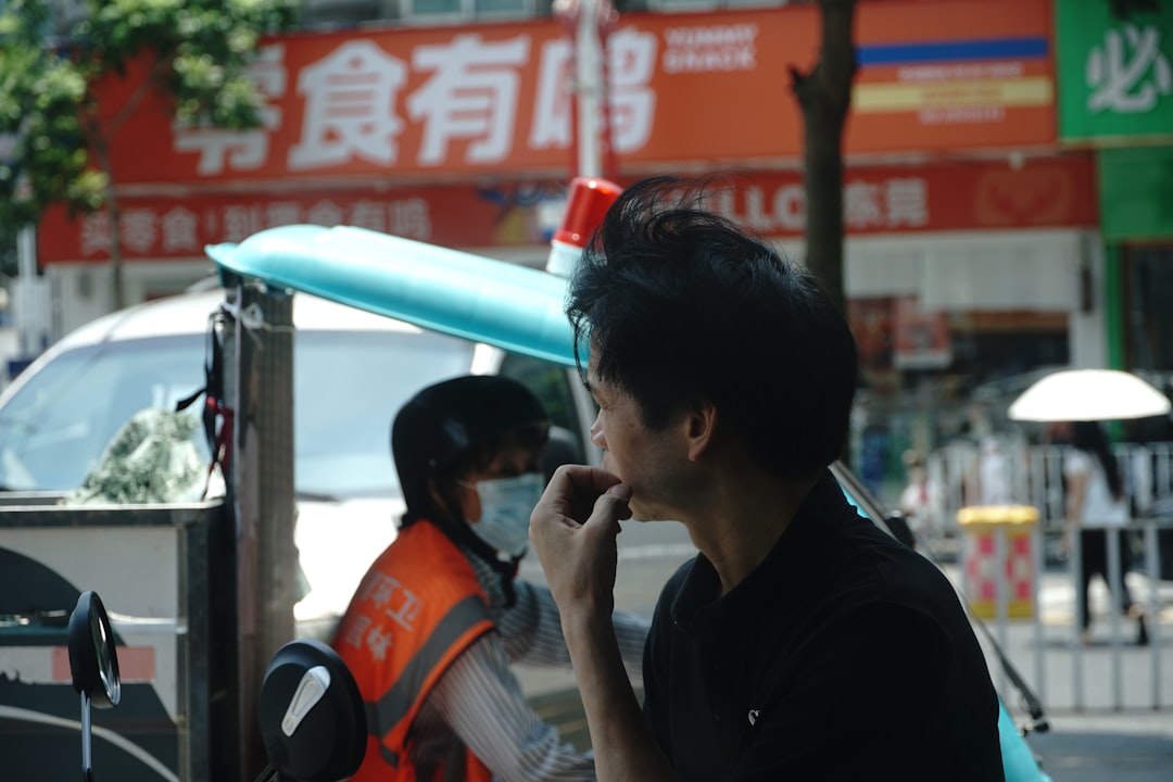 Man in black shirt looking away from camera