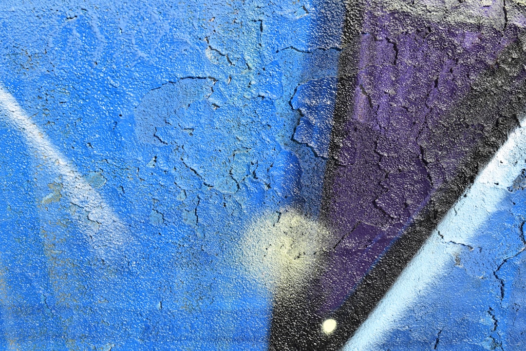 a close up of a blue and purple wall