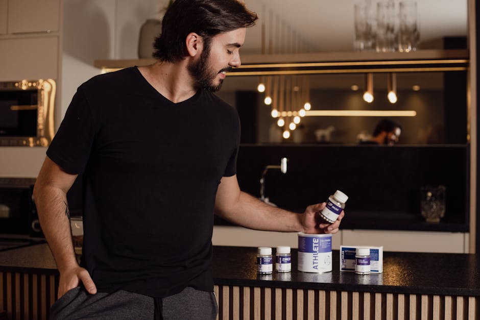 A man examines supplement bottles on a modern kitchen counter, reflecting a healthy lifestyle.