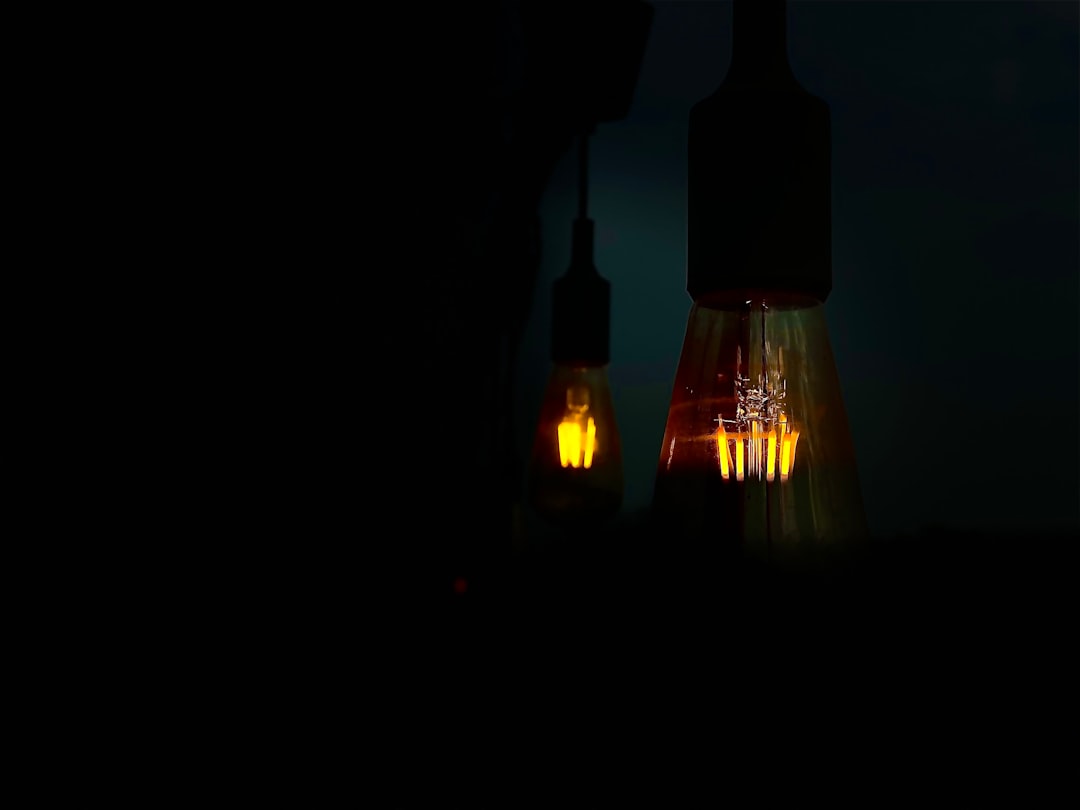 three lighted yellow and black lantern lamps