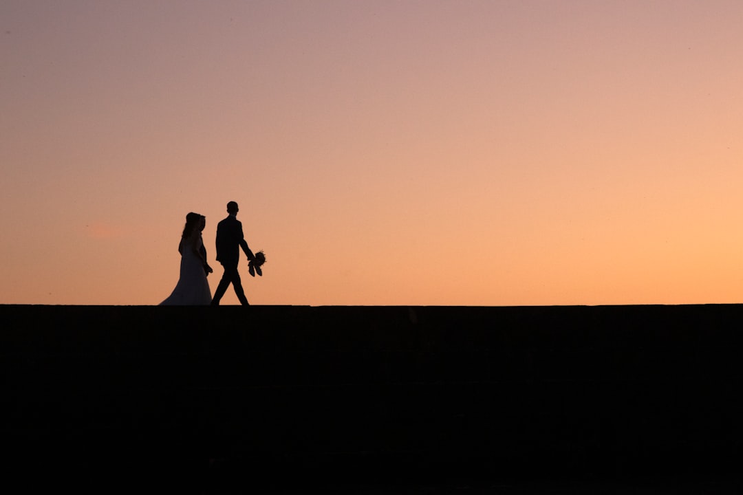 silhouette of two people during golden hour