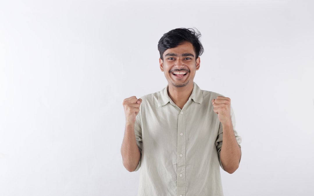 A man standing in front of a white wall